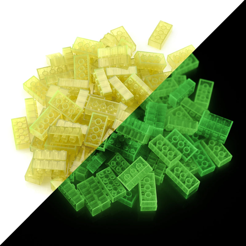 Models built from building bricks on a bedside table, glowing greenish in the dark