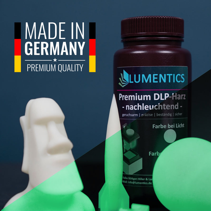 Glow in the dark 3D printing resin: glowing Moai figure, resin bottle and 3D printer in the half-dark