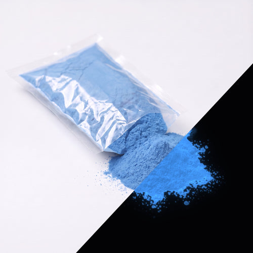 Fine glow pigment Blue-Blue 100 g: cut-open bag and a small heap of fine powder, blue by day, glowing blue in the dark (lower right)