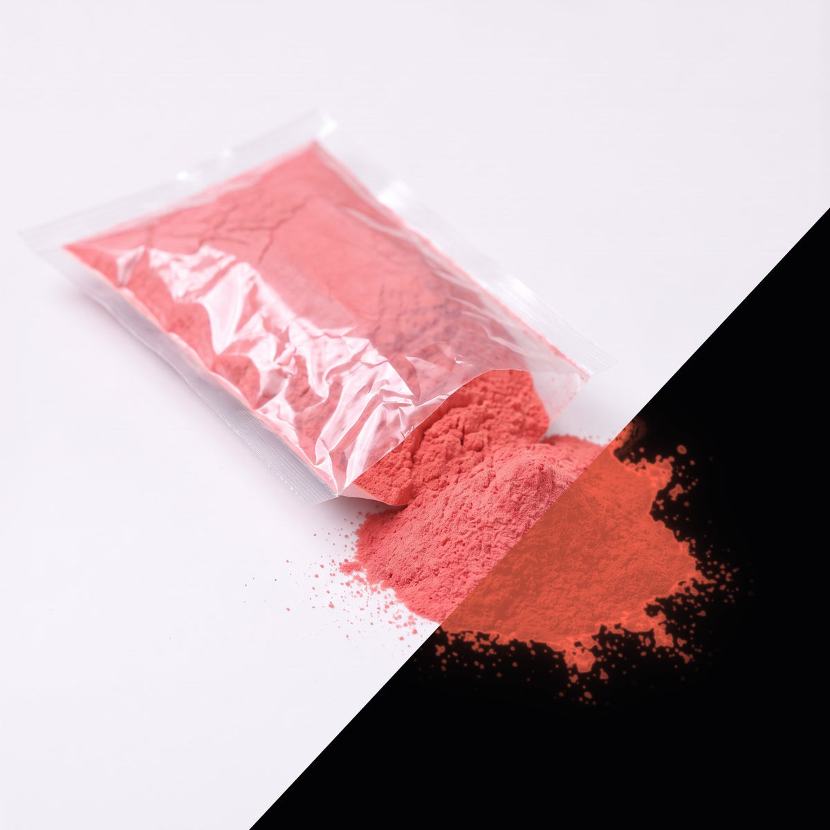Fine glow pigment Red-Red 100 g: cut-open bag and a small heap of fine powder, light red by day, glowing reddish in the dark (lower right)