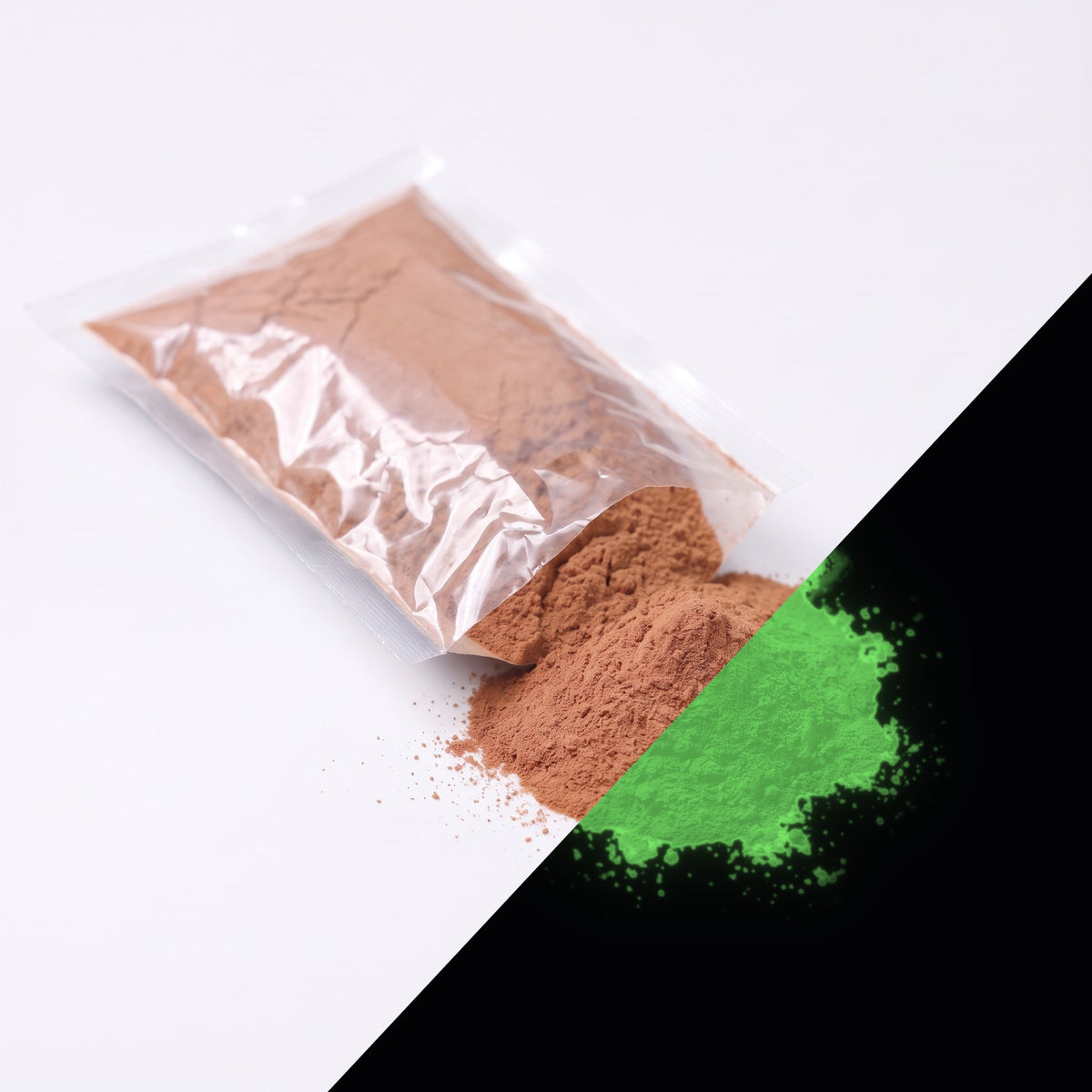 Fine glow pigment Terracotta 100 g: cut-open bag and a small heap of fine powder, brownish by day, glowing green in the dark (lower right)