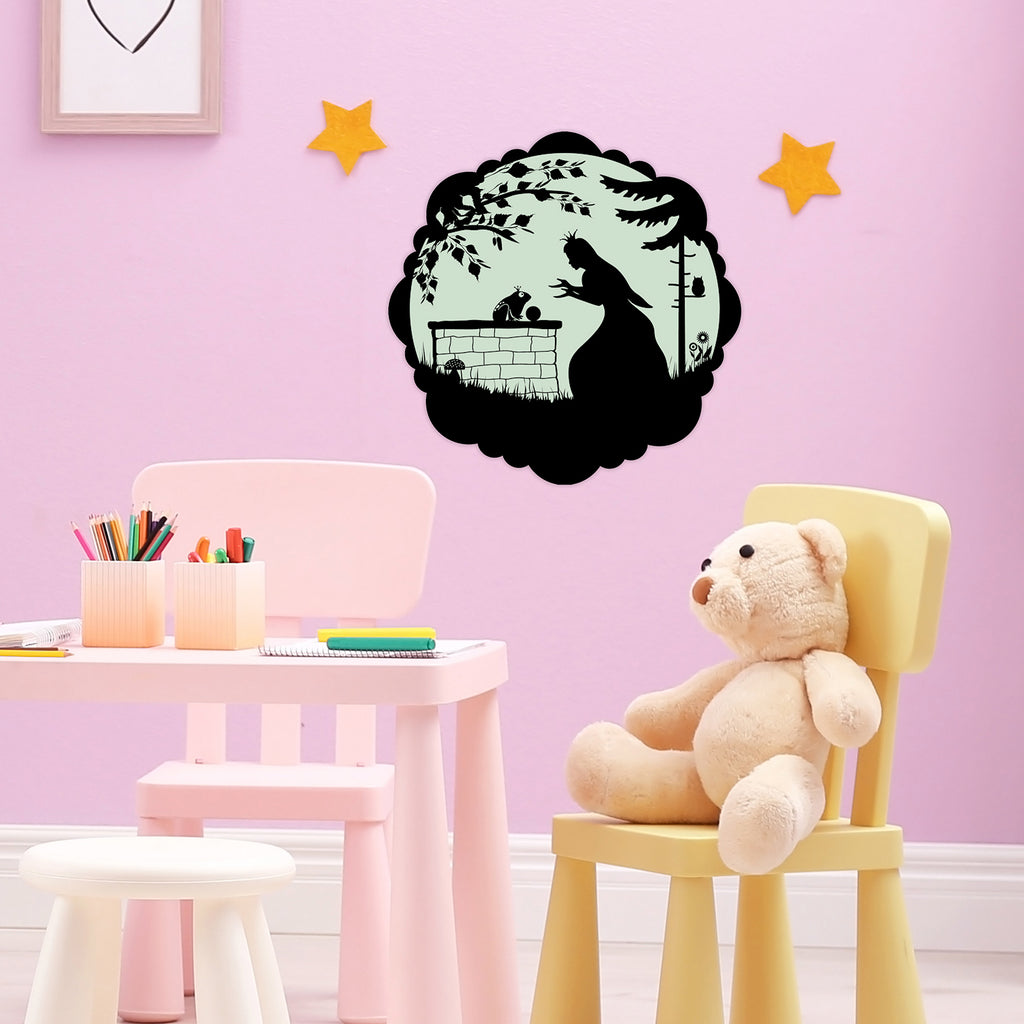 Fairy-Tale Sticker The Frog Prince 30 cm on a pink children's room wall above a table and teddy bear, in daylight