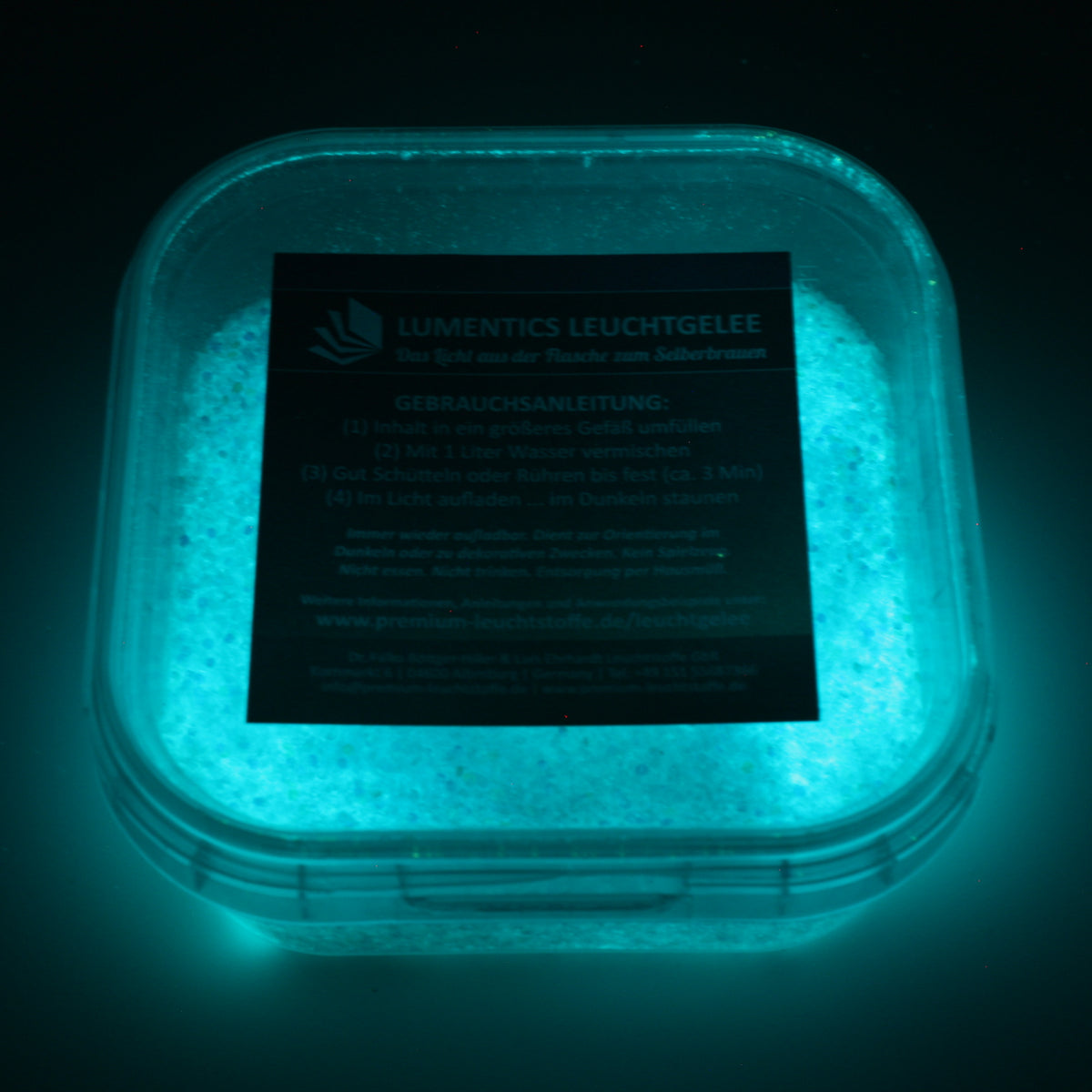 Glow Jelly with Glitter Blue/Blue-Green 45 g in its tub, glowing blue-green in the dark