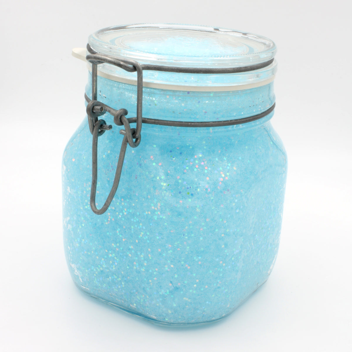 Glow jelly with glitter, mixed in a clip-top jar in daylight, light blue with glitter