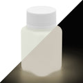 Glow in the Dark Paint Natural White 100 g bottle, split diagonally: whitish in daylight, glowing warm whitish in the dark