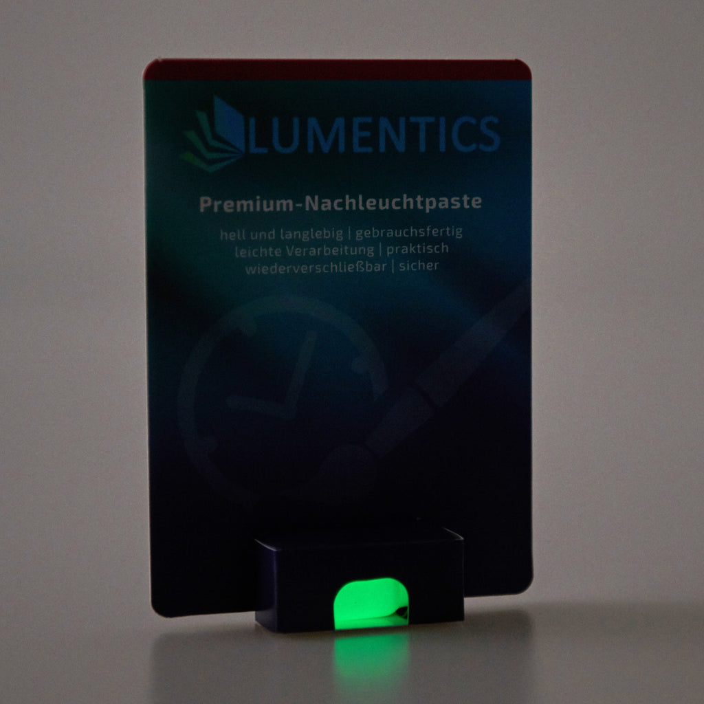 Luminous Paint for Watch Hands Yellow-Green 2 g: card in dim light, the paste in the tub glowing green