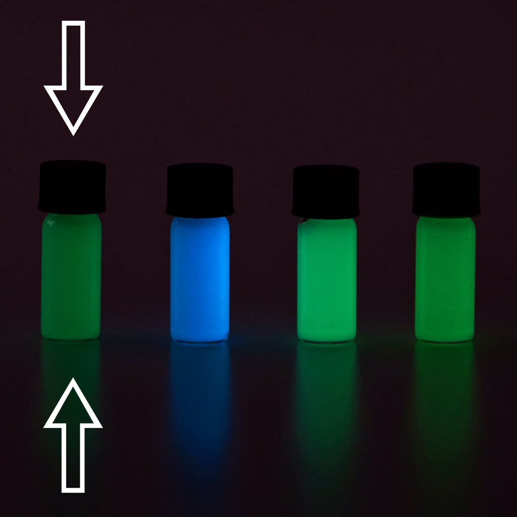 Glow paste: four small vials in the dark, glowing green, blue, light green and green