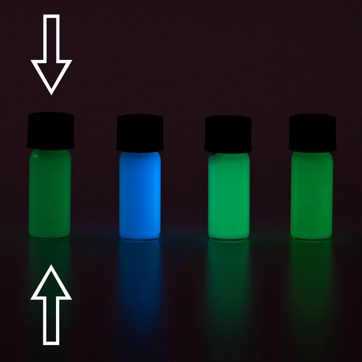 Glow paste: four small vials in the dark, glowing green, blue, light green and green