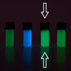 Four small vials with colour samples in the dark, glowing green and blue, arrows marking one vial