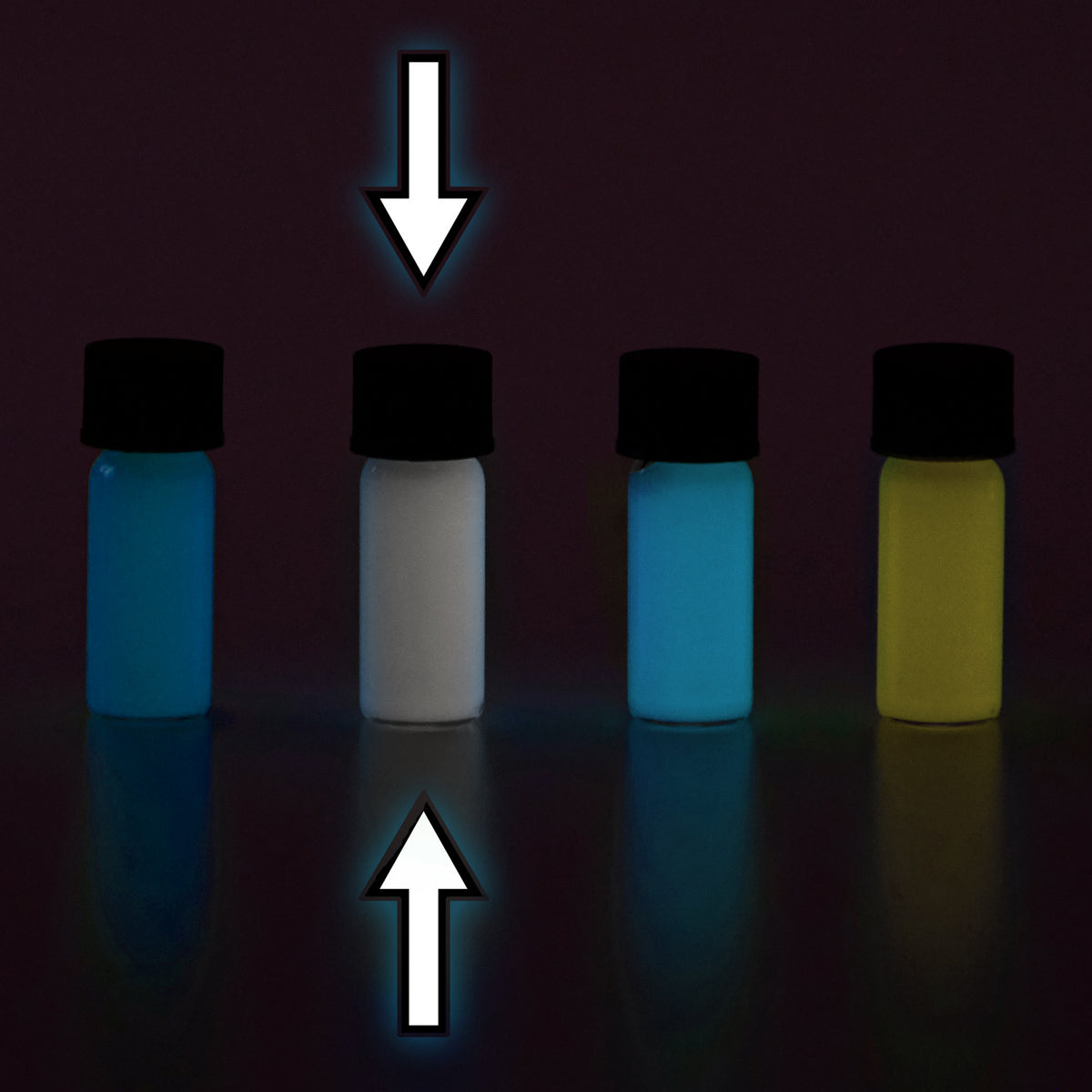 Glow paste colour variants: four vials in the dark, arrows marking the second, one glowing white