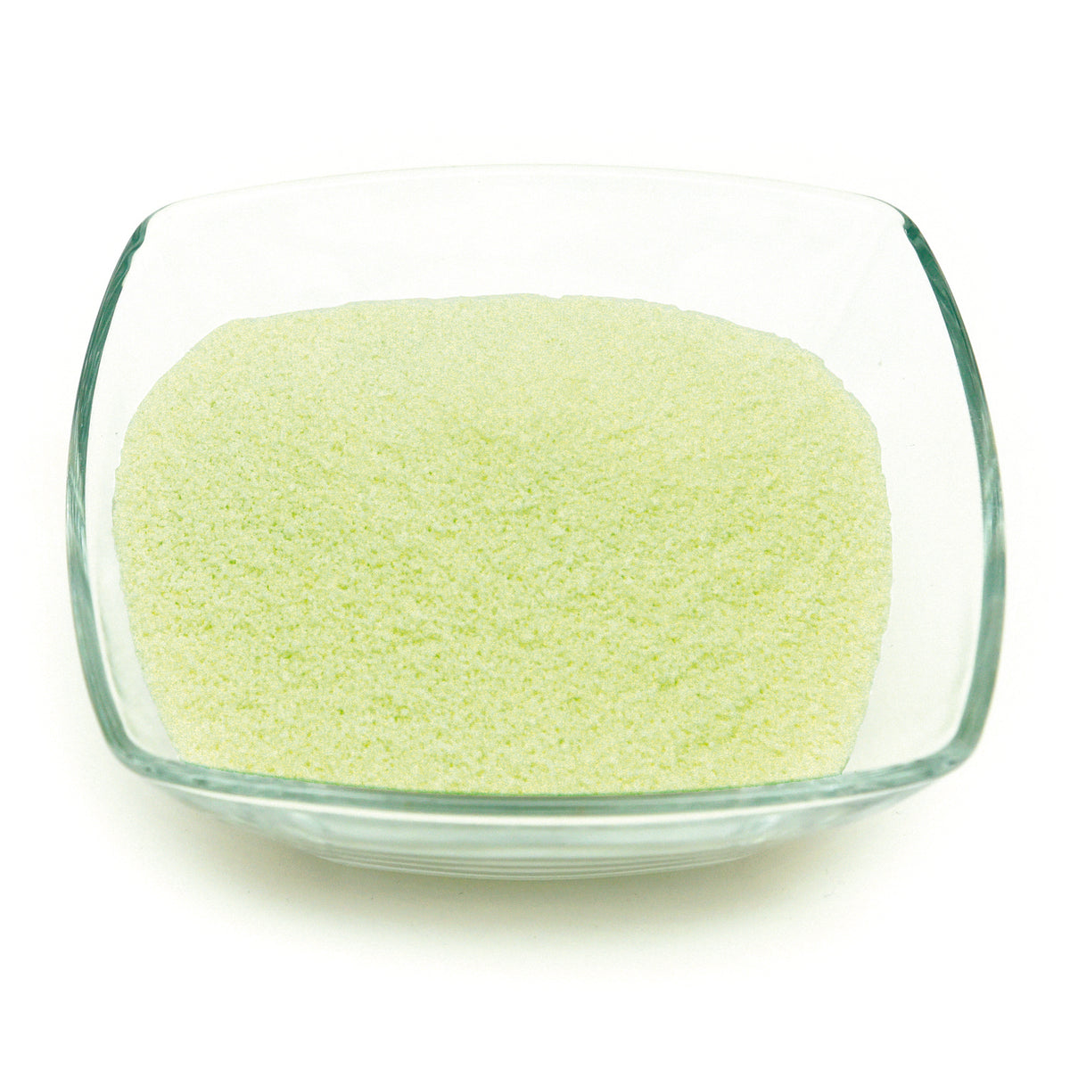 Glow granules 1 mm in a glass dish in daylight, pale green fine-grained granules