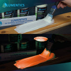 Glow in the dark varnish Orange 250 ml applied with a brush on a wooden board: whitish in daylight above, glowing orange in the dark below