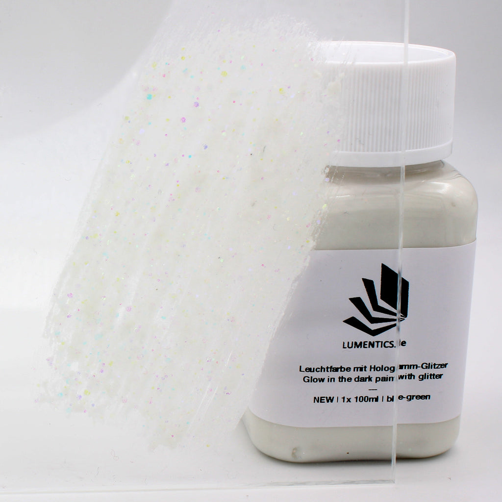 Glitter Glow Paint Blue-Green 100 g: labelled bottle and a glitter paint stroke on acrylic glass in daylight