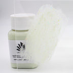 Glitter Glow Paint Yellow-Green 100 g: bottle with a paint stroke on an acrylic sheet in daylight, glitter visible