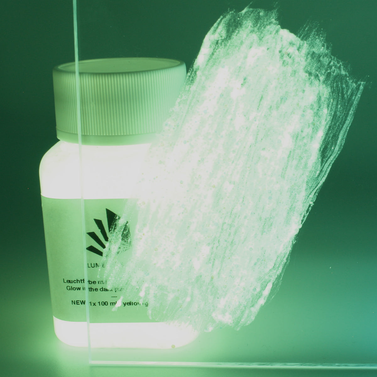 Glitter Glow Paint Yellow-Green 100 g: bottle with a paint stroke on an acrylic sheet in the dark, glowing green