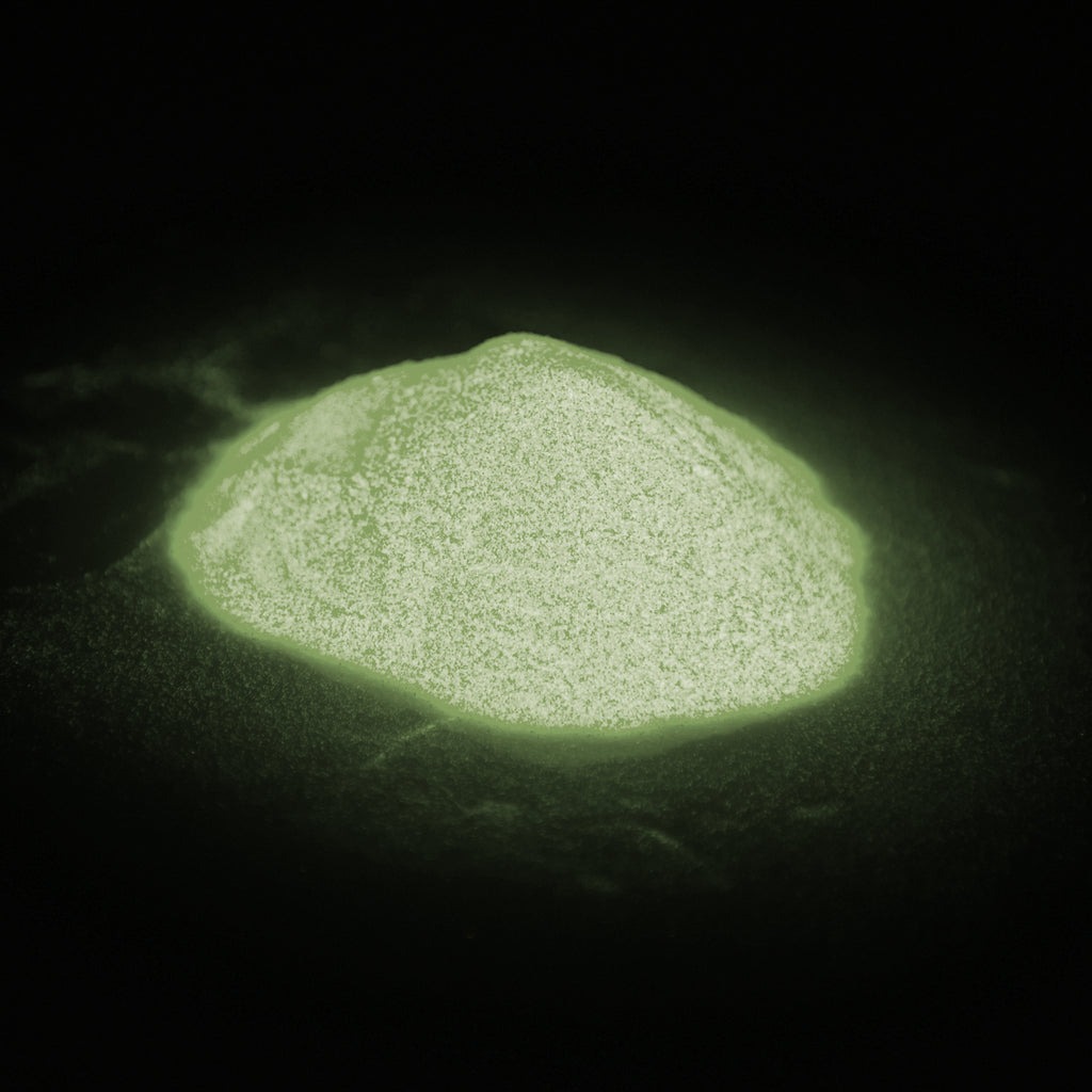 Glitter powder yellow 50 g: small heap glowing green in the dark