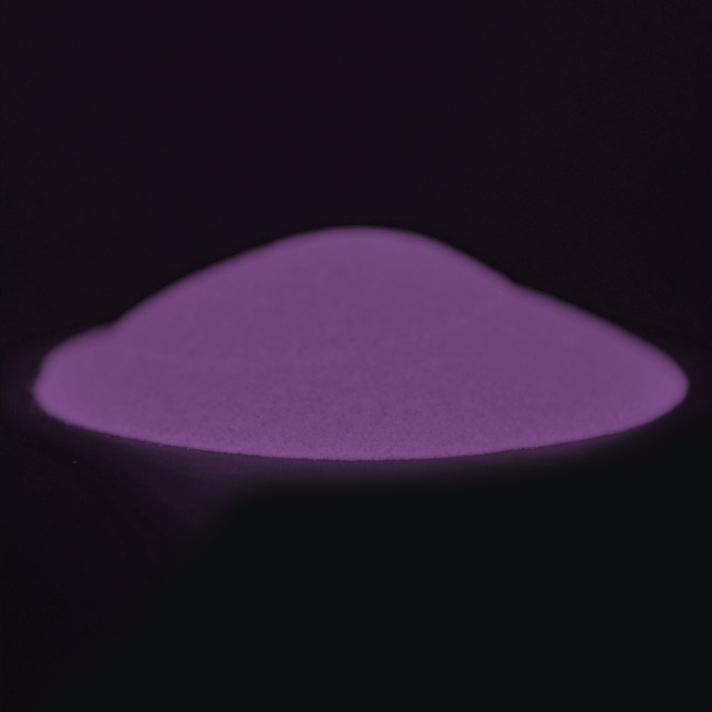 Glow in the Dark Powder Pink-Ocean Pink 40 g: pile of powder in the dark with a violet afterglow