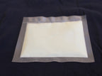 Glow in the Dark Powder Natural Green 40 g, 150 µm: heap glowing green in the dark, close-up