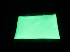 Glow in the Dark Powder Natural Green 40 g, 150 µm: pouch glowing light green in the dark