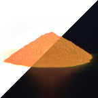 Glow in the Dark Powder Orange 40 g: heap of powder, orange in daylight on the left, glowing faintly in the dark on the right