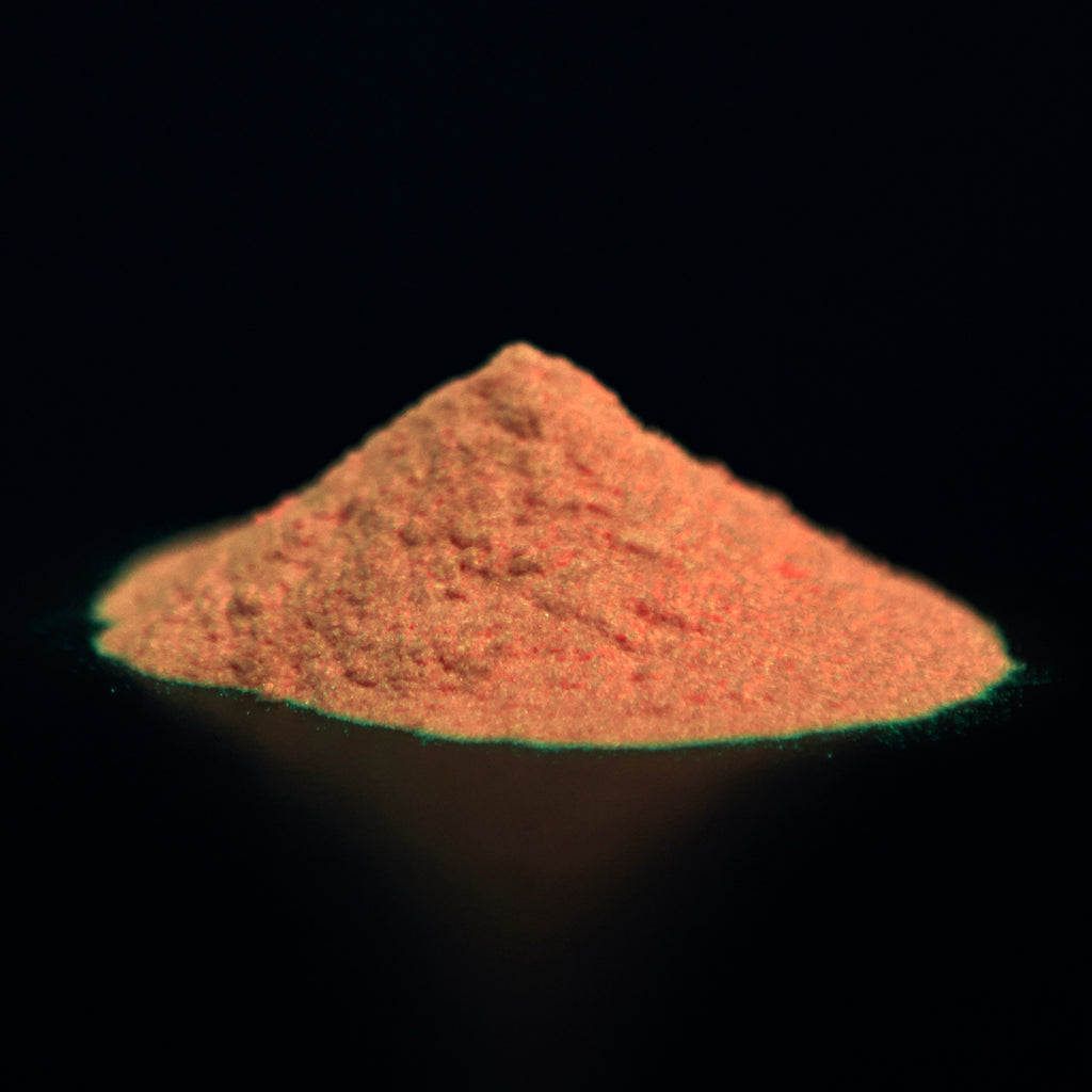 Glow in the Dark Powder Red 40 g: pile of powder in the dark with an orange afterglow