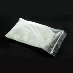 Powder Coating Blue-Green 1 kg as white powder in a zip bag in daylight