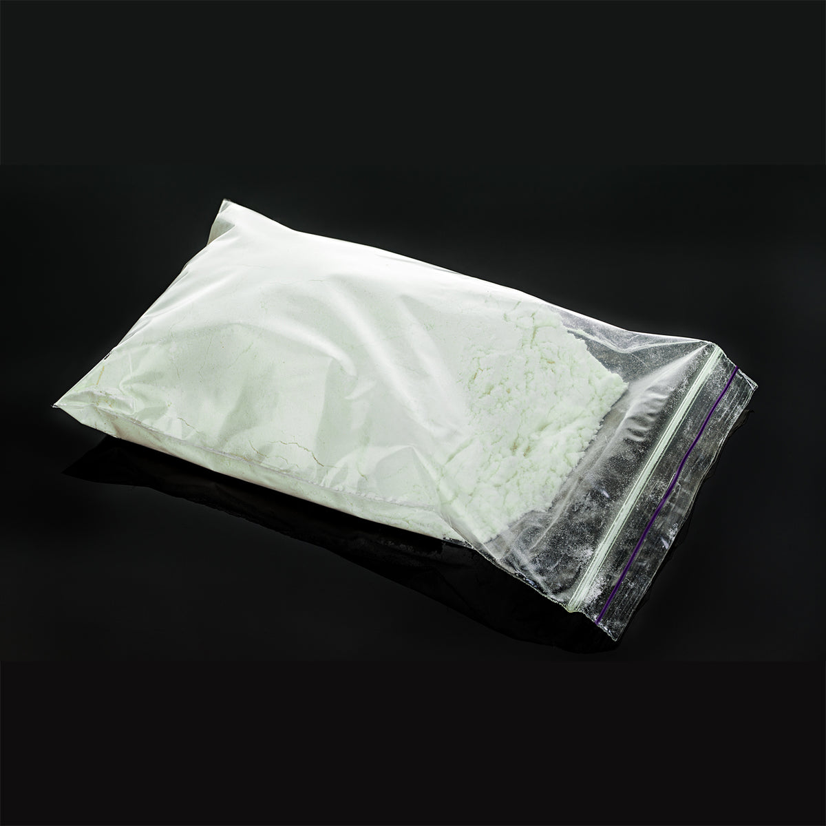 Powder Coating Blue-Green 1 kg as white powder in a zip bag in daylight