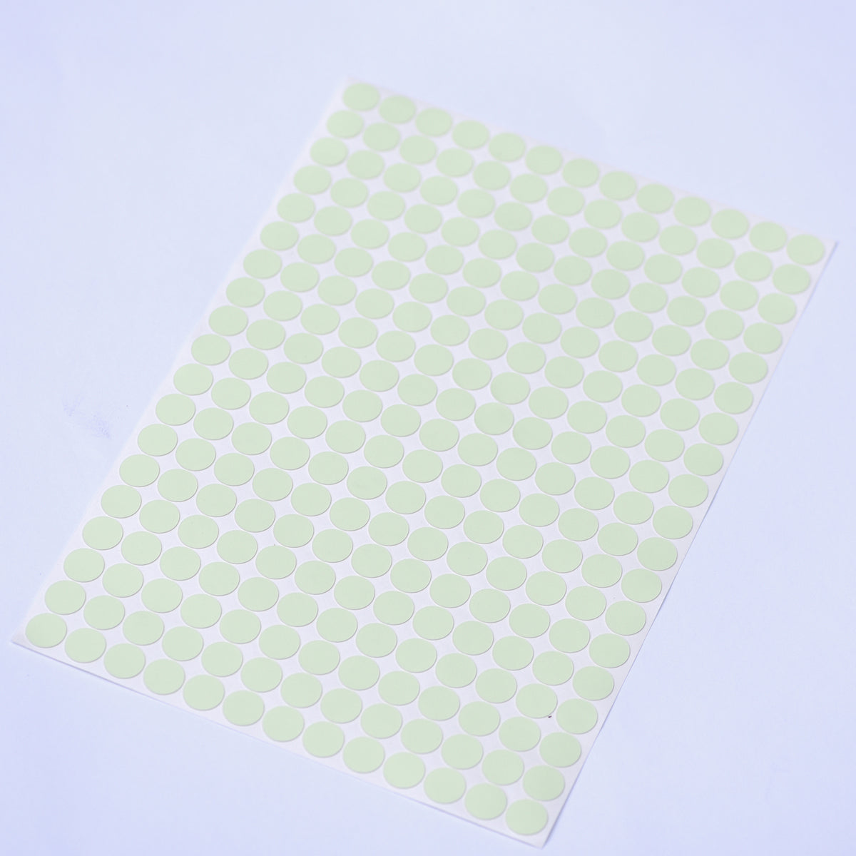 Glow dots 1.5 cm in daylight, sheet lying at an angle with 257 pale green dots