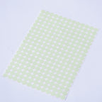 Glow dots 1.5 cm, sticker sheet seen from above at an angle with the dots arranged in rows