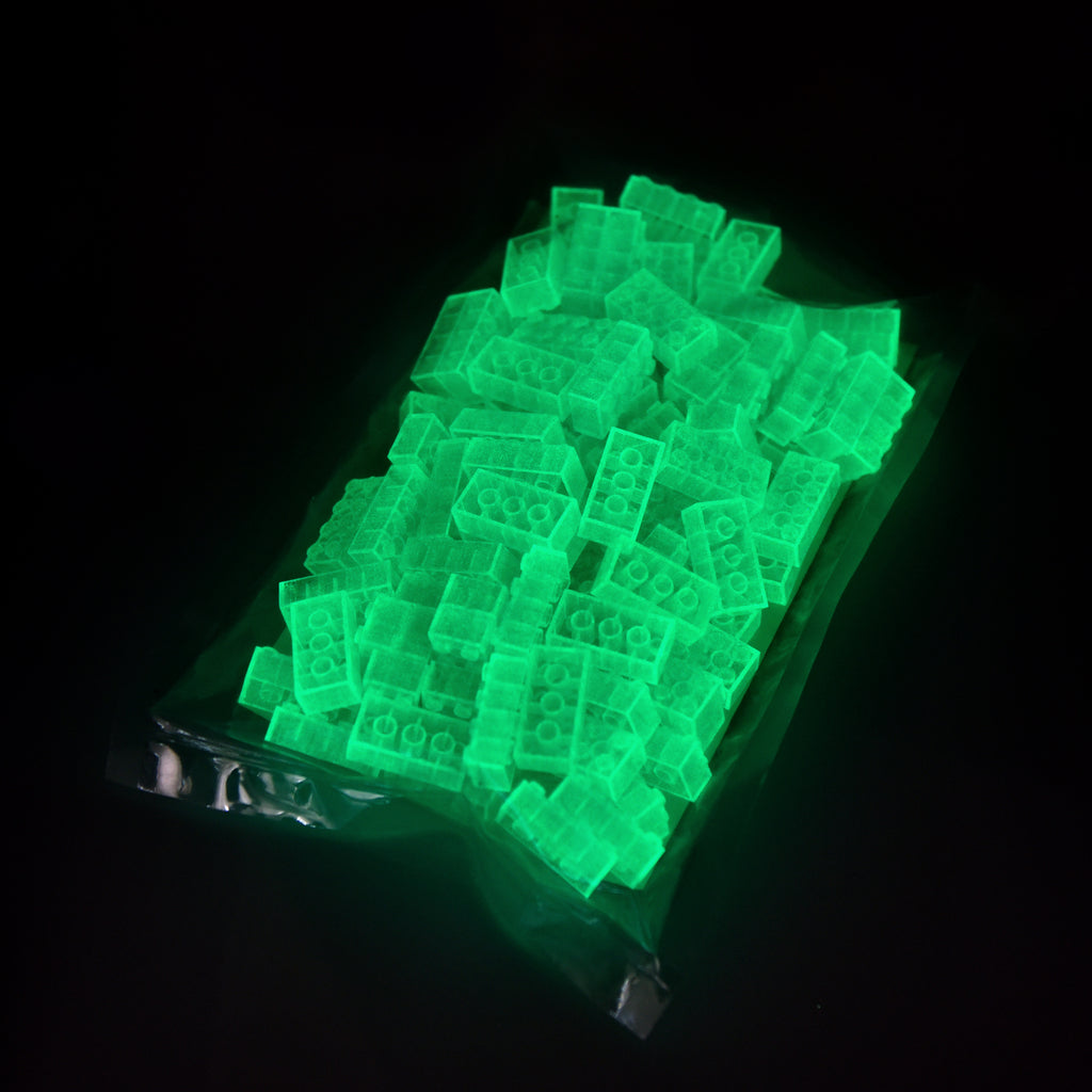 Building bricks 2x4 blue in the film bag, glowing green in the dark