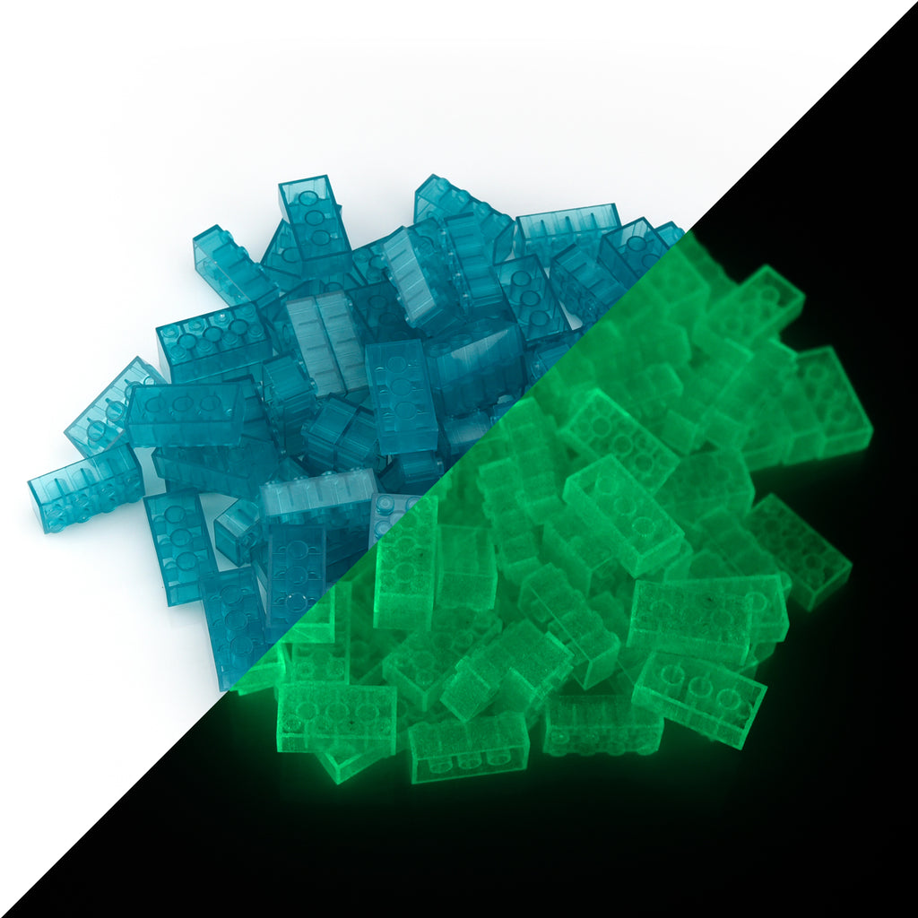 Building bricks 2x4 blue: pile in daylight, split diagonally with green glow in the dark