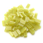 Building Bricks 2x4 Yellow in a pile in daylight, translucent yellow