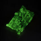 Building Bricks 2x4 Yellow in their bag in the dark, glowing green