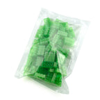 Clear bag with 100 green 2x4 building bricks in daylight, showing the packaging