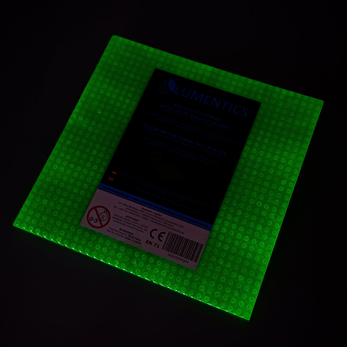 Glow-in-the-dark baseplate green with packaging label, glowing green in the dark