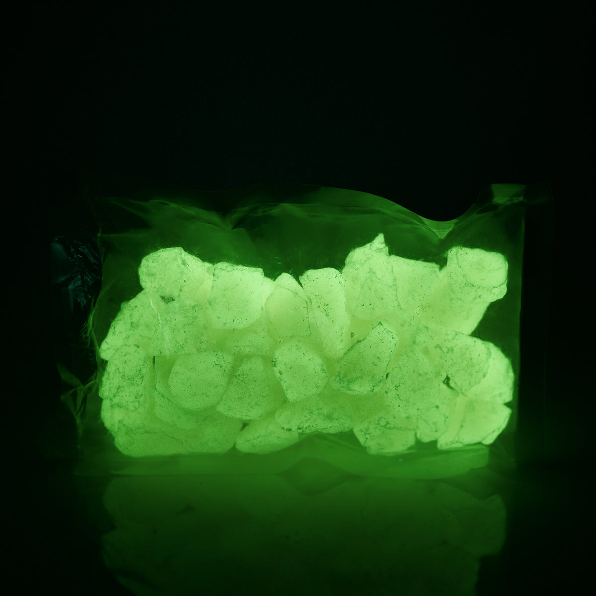 Glow Stones Yellow 300 g in their bag in the dark, glowing yellow-green
